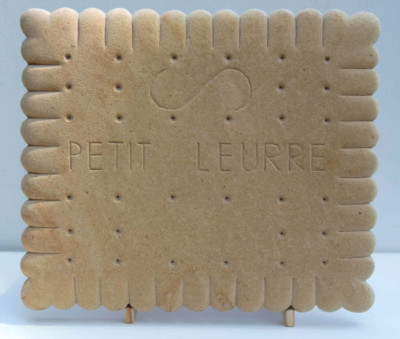 Petit Leurre - François LACOSTE Sculpture en bois d'un petit beurre sur lequel est écrit 'Petit leurre"